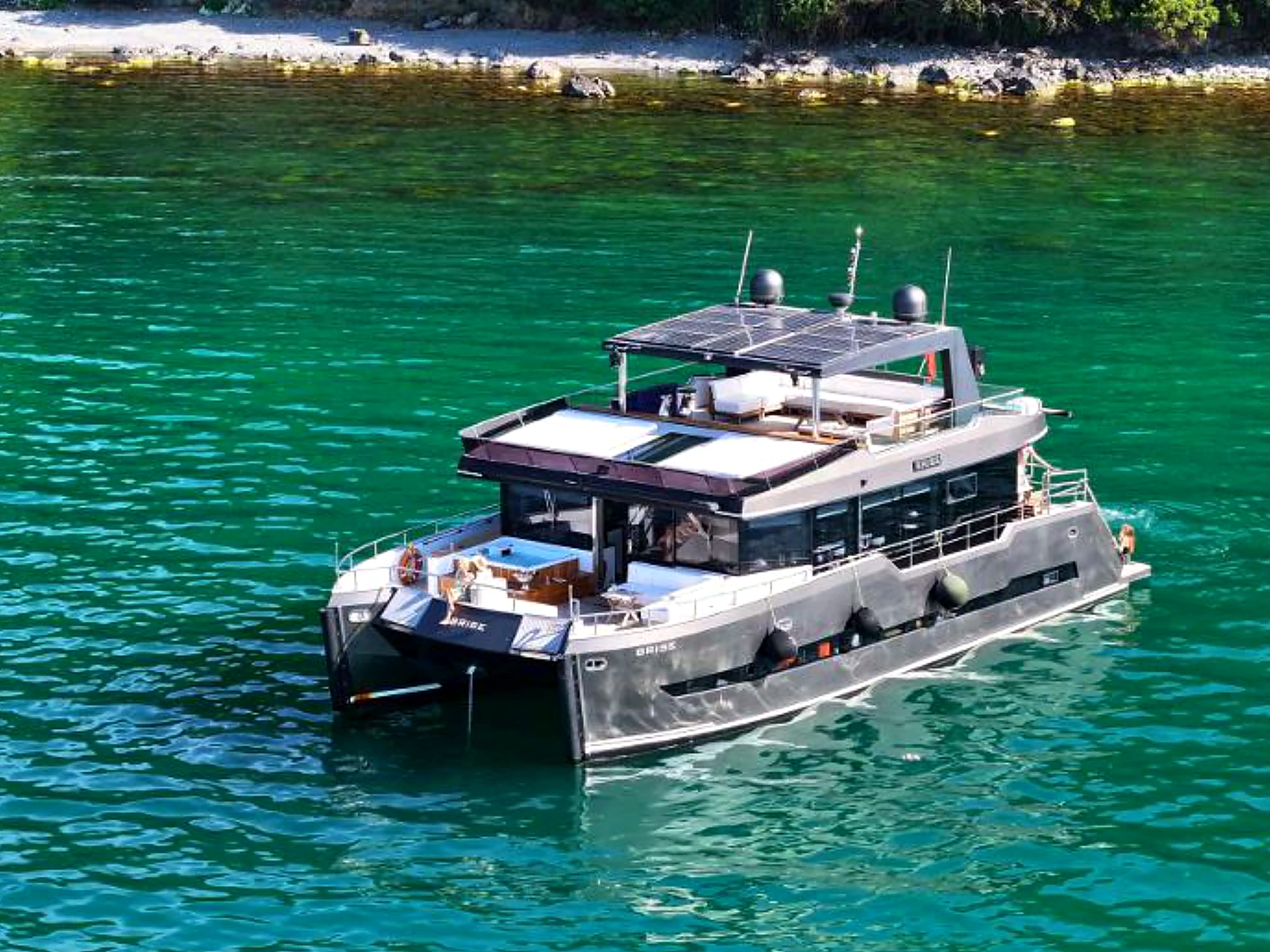 Bodrum Luxury 24M Catamaran profile at anchor in a turquoise cove in Bodrum